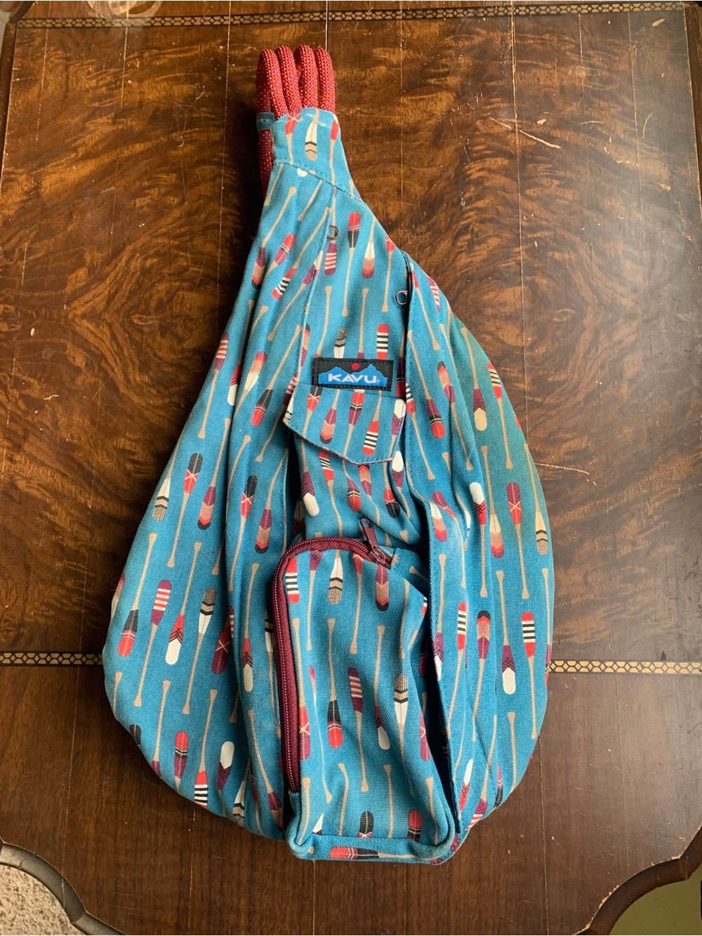 Kavu Teal Paddle-Print Rope Sling Crossbody Backpack with Maroon Accents